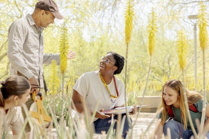 Students conducting fieldwork in an outdoor setting as an instructor supervises.