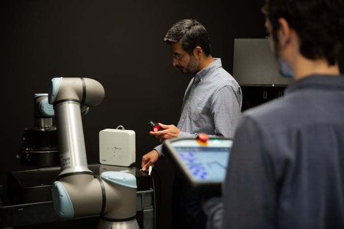 Marvi operating his robotic technology in his lab.