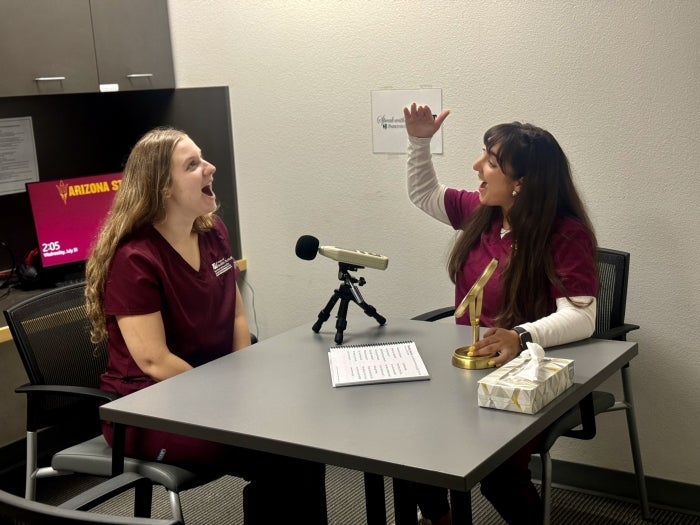 Two students practice voice therapy