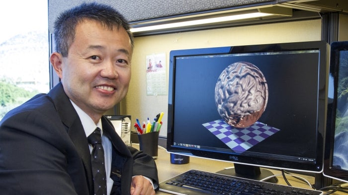 A portrait of Professor Yalin Wang in his office.