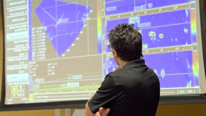 Ehsan Dehghan-Niri presents ultrasonic imaging data from inspection results using a phased array ultrasonic testing in the Intelligent Structures and Nondestructive Evaluation lab at ASU. Photographer Aisha Kaddi/ASU