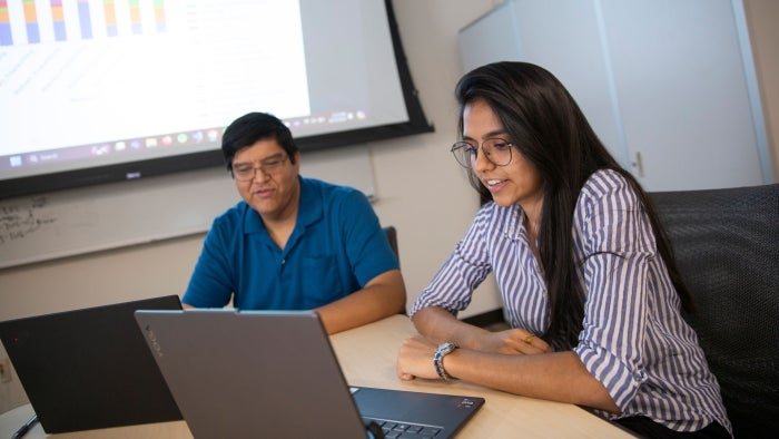 An ASU graduate student works on engineering education research with a faculty member.