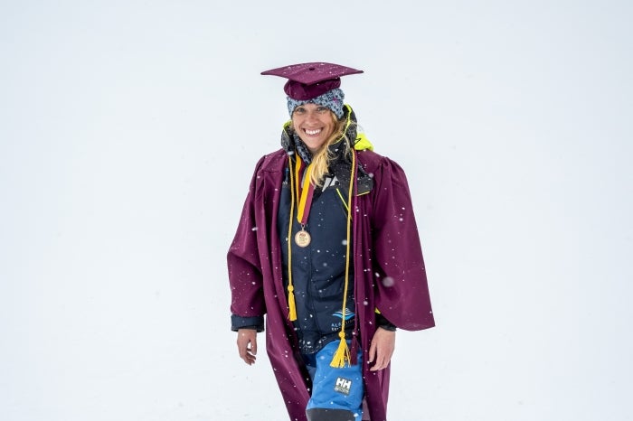 Lauren Richards wearing her ASU cap and gown in a snowy outdoor setting.