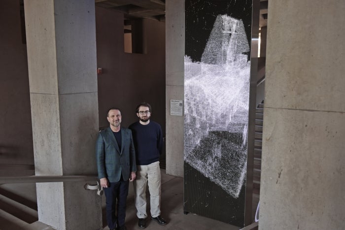 Robert Moric (left) and Avery Moric (right) standing beside the "Point Cloud (ASU)" art installation at the ASU Art Museum in Tempe, AZ.