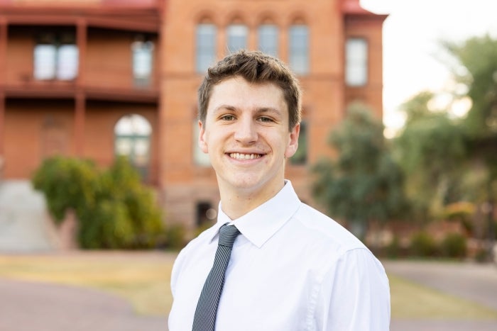 Headshot of Austin Adams in front of Old Main on Tempe campus.