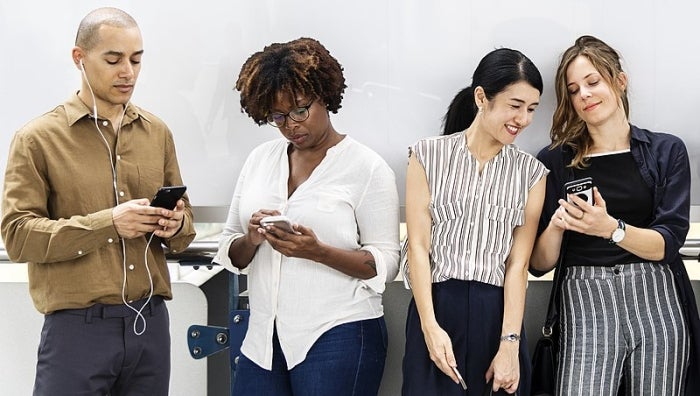  Public domain image of people using smartphones from Rawpixel, via Wikimedia Commons. 