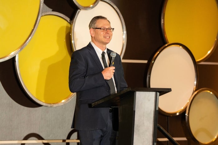 Man in glasses holding microphone