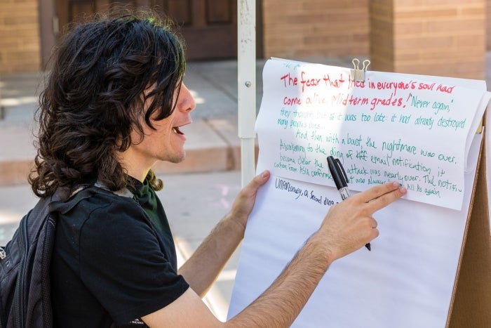 A student gestures while discussing their contribution to a “never-ending story” at the ASU National Day on Writing Celebration in 2019. Photo by Bruce Matsunaga / ASU.