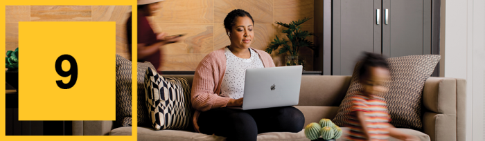 Woman sitting on the couch with her laptop.