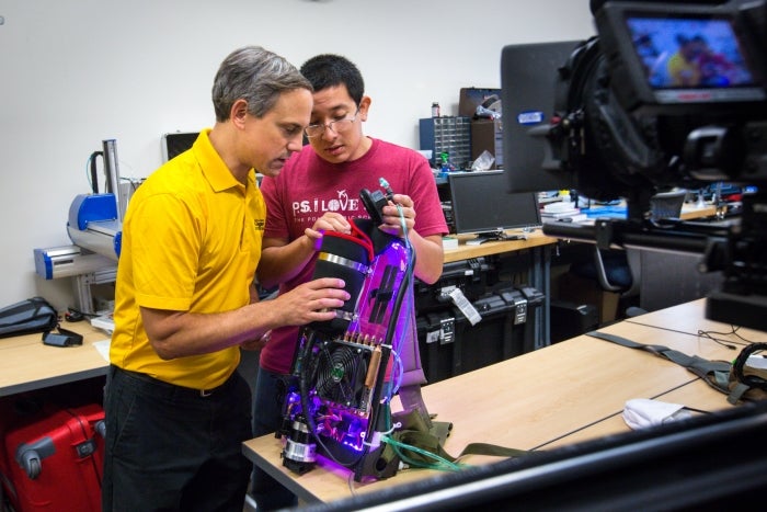 two men working on wearable robotic project