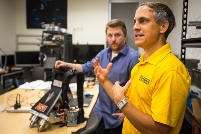 man talking in robotics lab