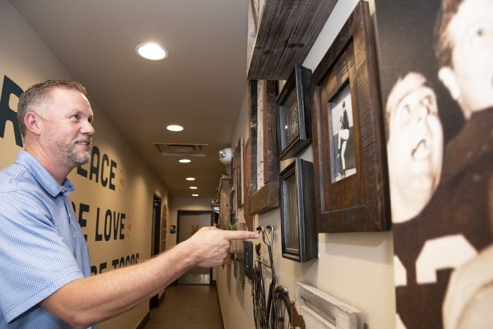 Tim Vasquez shows family photos and black-and-white images of the early days of the restaurant. Today they hang on the walls of Someburros locations around the Valley.