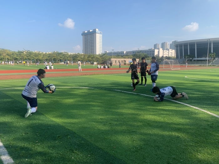 People playing soccer on a field.