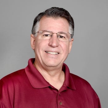 Portrait of older man in red polo wearing glasses