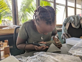 Linet Sankau drilling for animal fossil tooth enamel at the museum in Nairobi