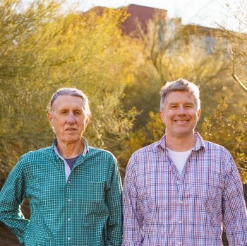 President’s Professor Douglas Kenrick and Dave Lundberg-Kenrick smile at the camera.