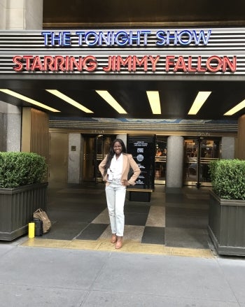 Latavia Young poses for the camera beneath the marquee for "The Tonight Show Starring Jimmy Fallon"