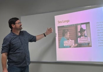 Man pointing to a screen in a classroom