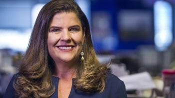 Woman with long brown hair smiling