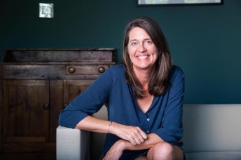 Woman in blue shirt on couch