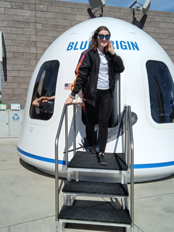 Student standing in front of a white structure