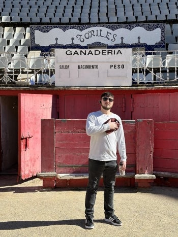 Lucas Glick stands inside a bull fighting ring in Barcelona, Spain