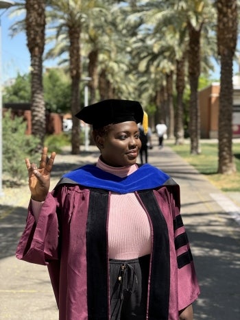 A woman holding up the "forks up" symbol on palm walk.