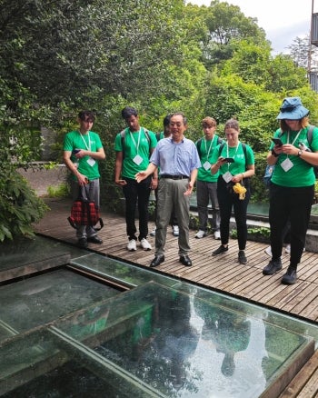 Tongji University Professor Siqing Xia shows the summer school participants a membrane bioreactor for treating urban stormwater.