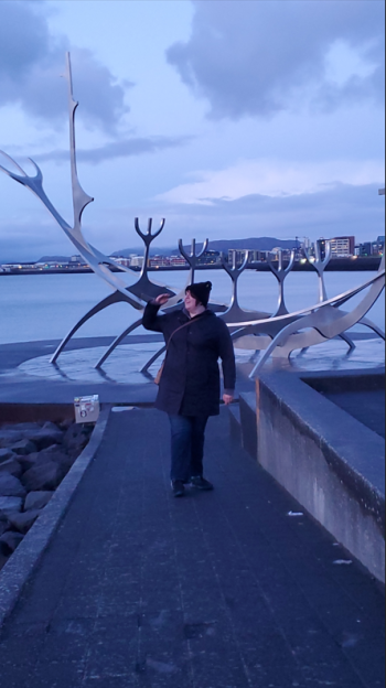 Photo of Alexis Phillips with Sun Voyager sculpture in Reykjavik, Iceland.