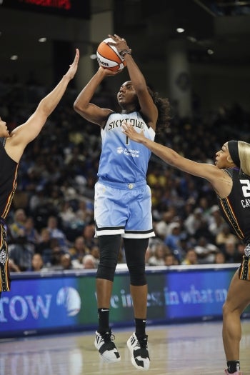 Woman shooting a basketball