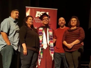 Family pose for a photo with ASU alum Martine Garcia Jr.