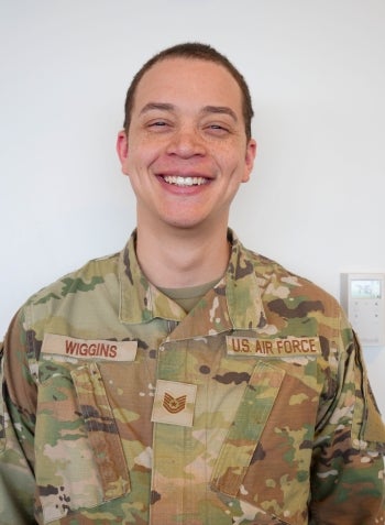 Wiggins in military uniform smiling at the camera