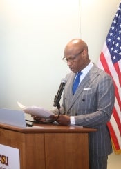 Man reading speech at lectern