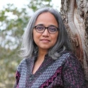 Portrait of woman with medium length gray hair wearing glasses