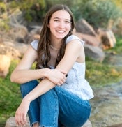 Young woman sitting down and smiling