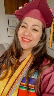 Selfie of Shannon Zellner wearing graduation regalia.