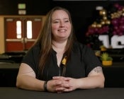 Edson College BSN Grad Samantha Gaughan is shown smiling, she is wearing a black top with her nursing pin visible on her blouse.