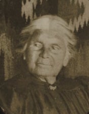 Black and white historical photo of a woman with white hair