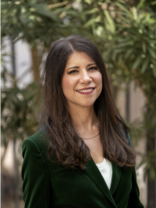 photo of Carmen Heredia in a green outfit outside