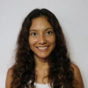 A woman with long dark hair smiling at the camera.