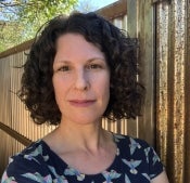 Woman standing next to fence