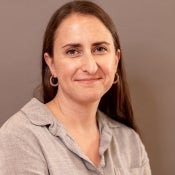 Woman with long brown hair smiling