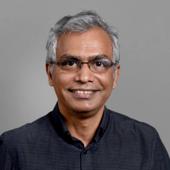 Man with grey hair and glasses