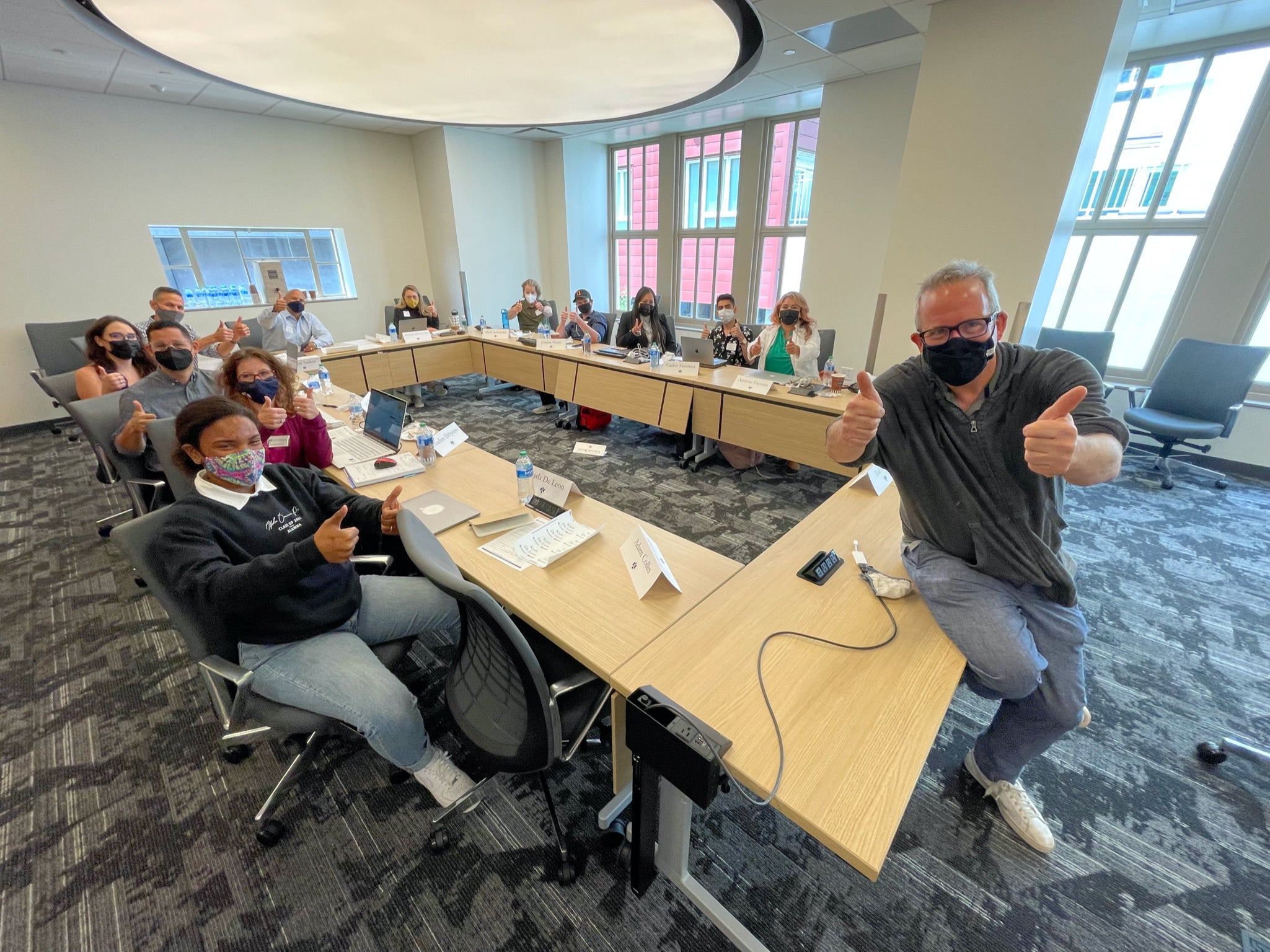 Professor Ted Hope gives two thumbs up in a classroom full of graduate students at ASU's California Center. 