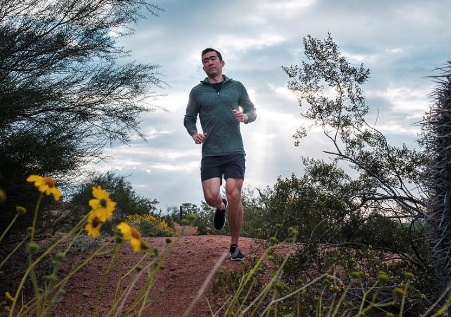 College of Health Solutions graduate  jogging on an outdoor trail.