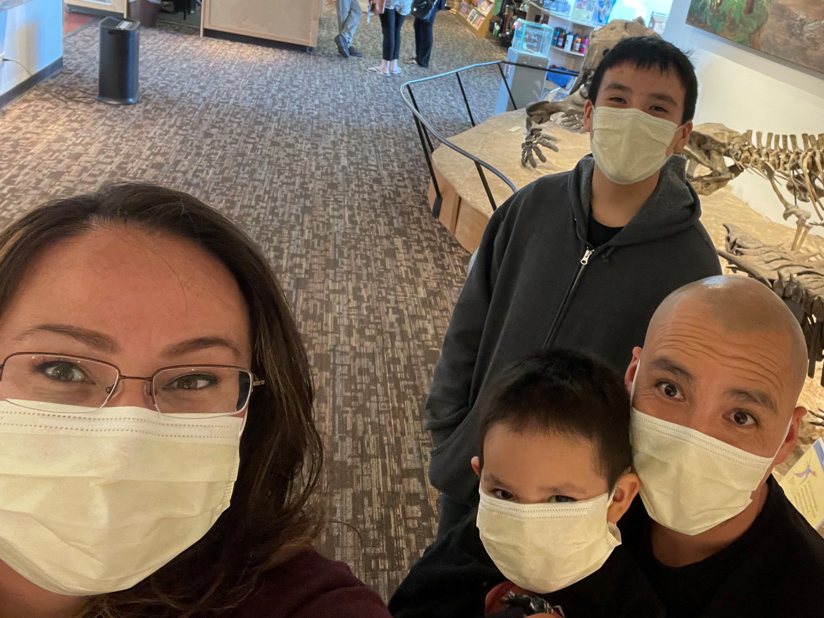 Scholarship recipient Tycarsha Velasquez is pictured with her partner and two kids. All four are wearing masks.