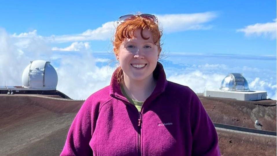 Woman standing in front of observatories 