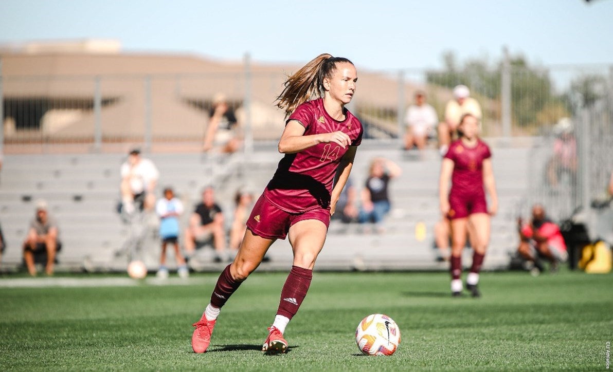 woman playing soccer during a match