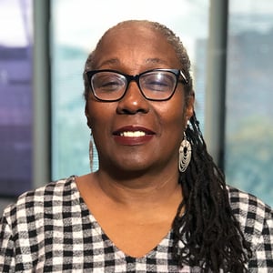 Woman in glasses in checkered dress