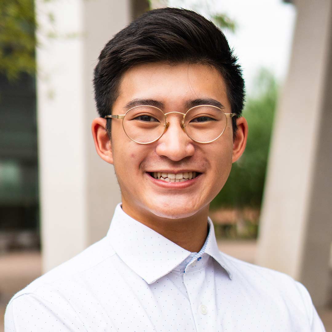 Undergraduate student  smiles at the camera.